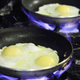 Eggs cooking in a nonstick pan, with a side of endocrine disruption.